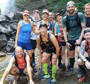 Group of runners in a waterfall in Costa Rica