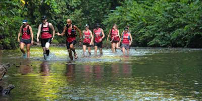Runners in and expedition by a Costa Rican river