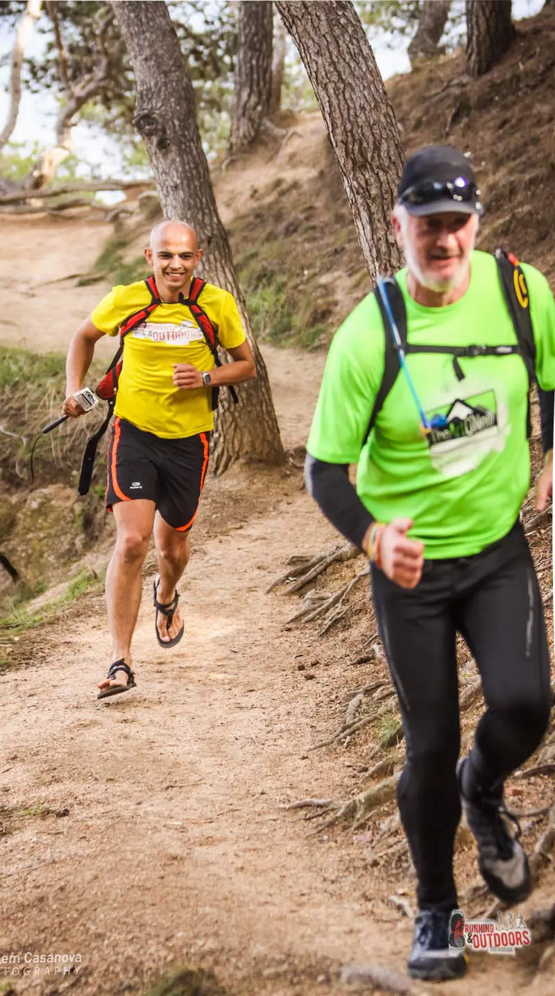 Two runners by a trail