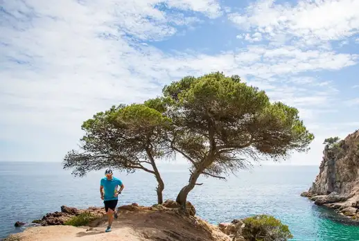 Men running by the Mediterranean Sea